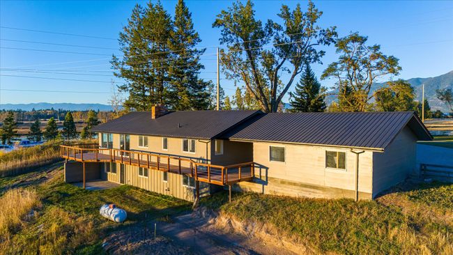 Back of house with a deck with mountain view | Image 45