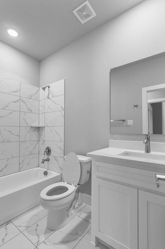 Full bathroom with visible vents, marble finish floor, toilet, vanity, and shower combination | Image 21