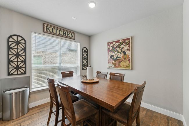 Dining area featuring baseboards, plenty of natural light, and wood finished floors | Image 16