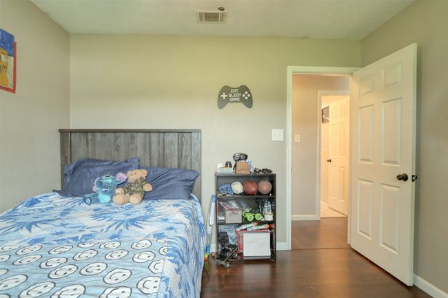 Bedroom featuring wood finished floors and baseboards | Image 32
