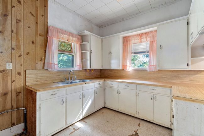 Kitchen with a sink, light countertops, a wealth of natural light, and open shelves | Image 8
