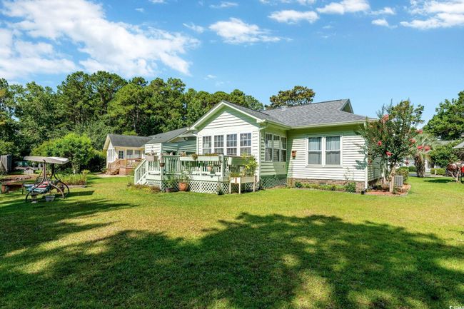 Rear view of property featuring a lawn and a wooden deck | Image 21