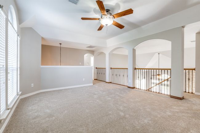 Carpeted spare room featuring visible vents, baseboards, ceiling fan, and a healthy amount of sunlight | Image 17