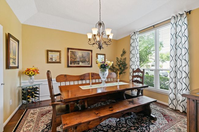 Tasteful formal dining room conveniently located adjacent to the kitchen, perfect for hosting dinner parties and special occasions. The seamless flow between spaces makes entertaining effortless while maintaining the sophisticated atmosphere for memorable gatherings. | Image 7
