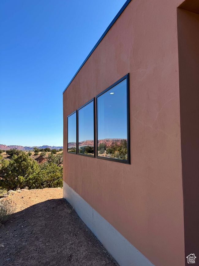 View of side of primary home with stucco | Image 11