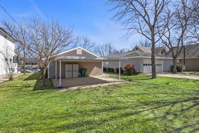 Back of house featuring a lawn, an attached garage, and driveway | Image 30