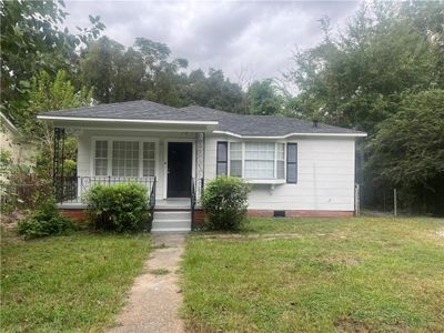 View of front of property with covered porch and a front yard | Image 1