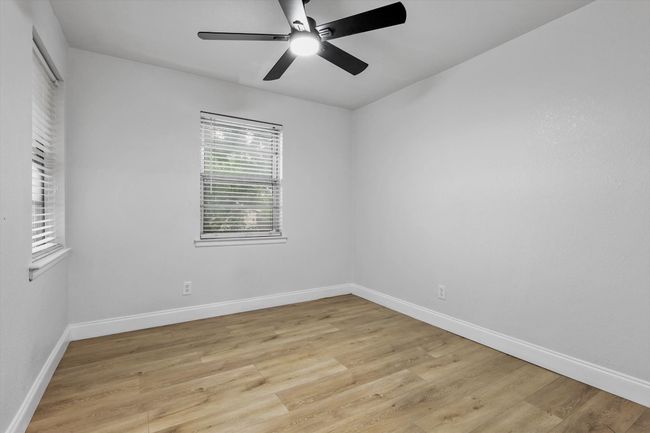 Empty room featuring baseboards, light wood-style flooring, and ceiling fan | Image 17
