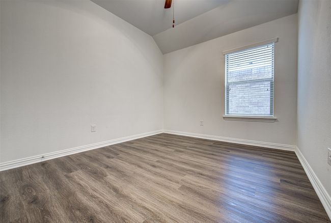 Empty room featuring ceiling fan, dark wood-type flooring, and lofted ceiling | Image 14