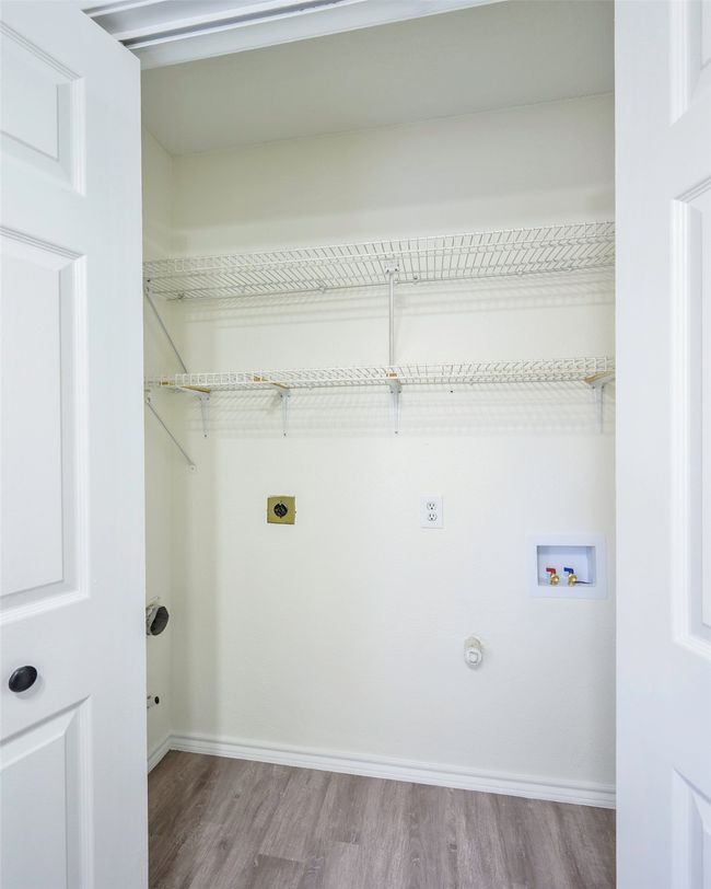 Washroom featuring electric dryer hookup, washer hookup, wood finished floors, hookup for a gas dryer, and laundry area | Image 15