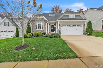 View of front of home featuring a garage and a front yard | Image 1