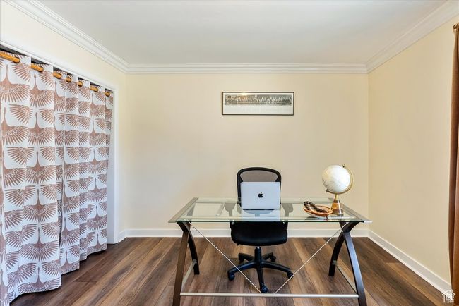 Office with ornamental molding and dark wood finished floors | Image 27