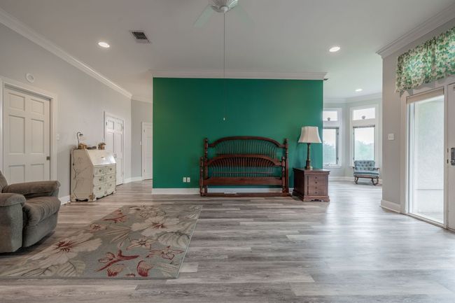 Bedroom featuring crown molding, wood floors, baseboards, recessed lighting, and ceiling fan | Image 20