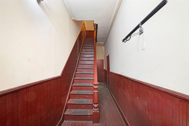 Staircase with wood walls and wainscoting | Image 6