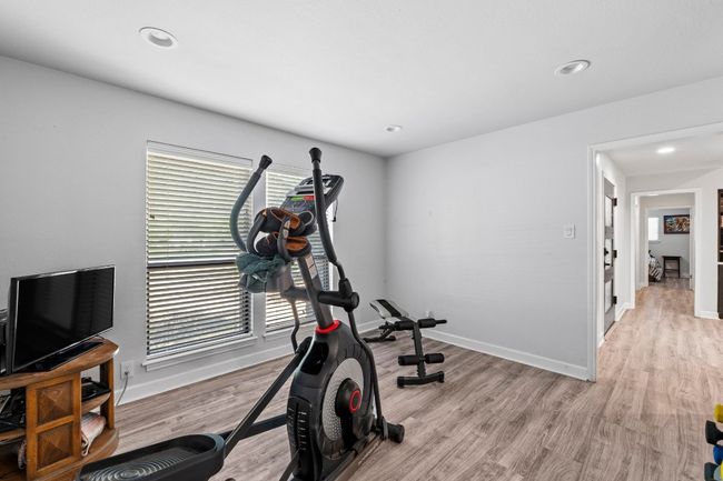 Currently set as workout area with recessed lighting, light wood finished floors. | Image 14