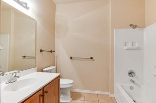 Full bathroom with vanity, tile patterned flooring, and shower / bath combination | Image 8
