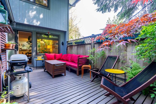 Wooden deck featuring fence, a grill, and outdoor lounge area | Image 23