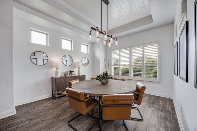Dining room with plenty of natural light, a tray ceiling, dark wood-type flooring, and wooden ceiling | Image 12