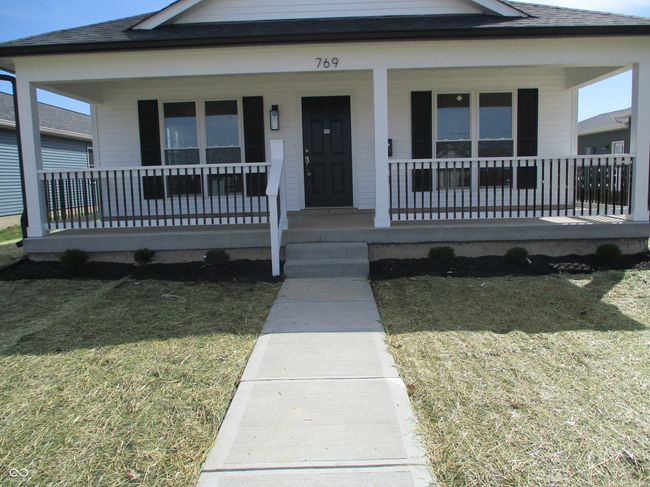 bungalow-style house with a porch, a front lawn, and a shingled roof | Image 18