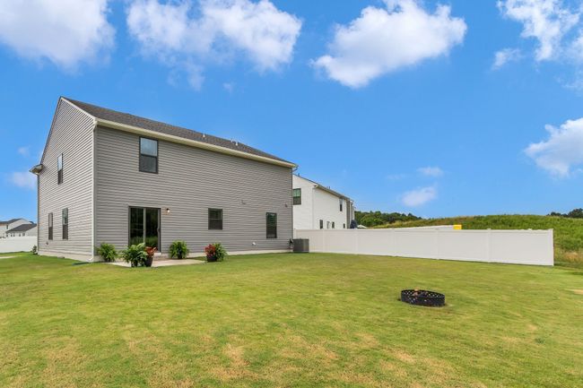 The backyard is spacious and versatile, whether you want to create a beautiful garden, set up a play area for the kids, or give your furry friends plenty of room to run around. It's truly a space full of possibilities! | Image 4