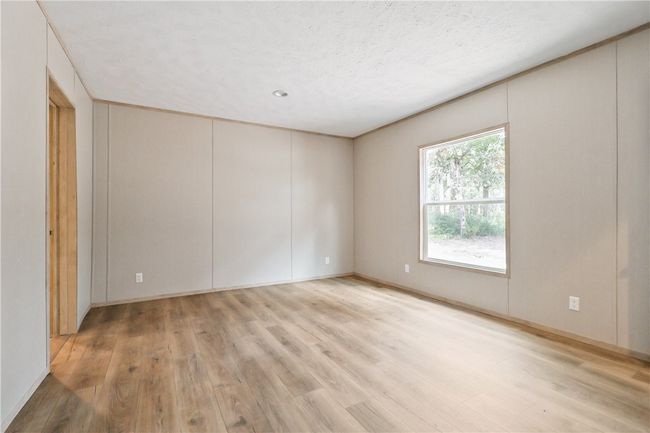 Spare room featuring light wood-style flooring and baseboards | Image 21