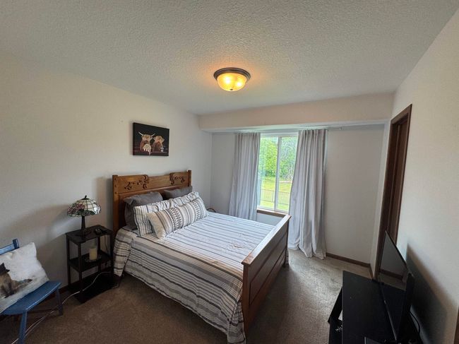 Carpeted bedroom featuring a textured ceiling | Image 22