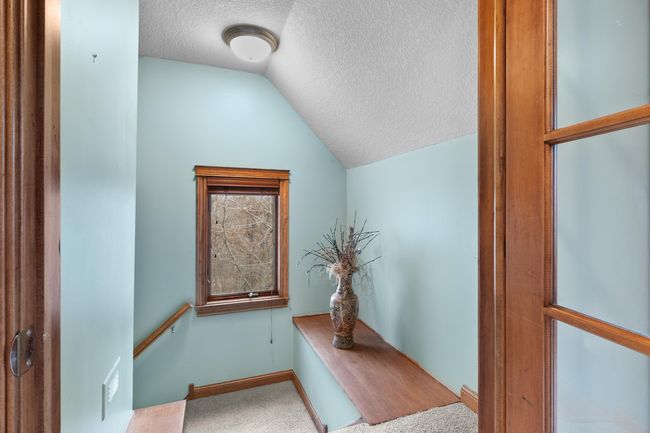 Upper-level stairway access from bonus room / private office to main-level hallway. | Image 40