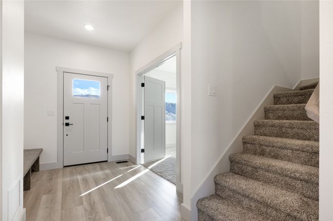 Foyer featuring light wood-type flooring, stairs, plenty of natural light, and recessed lighting | Image 11