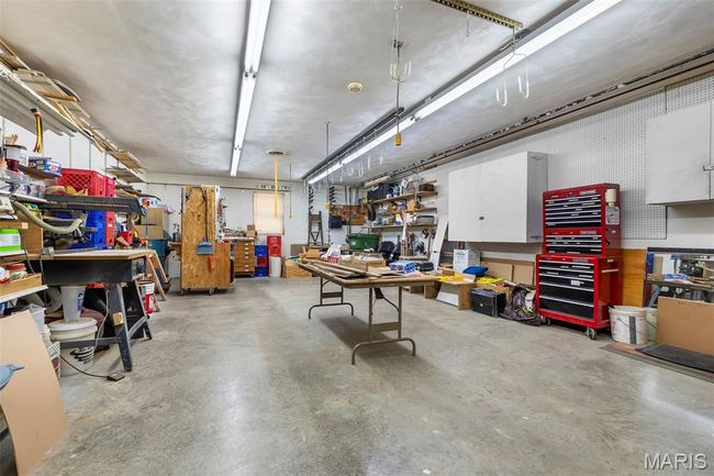 Garage featuring a workshop area | Image 54