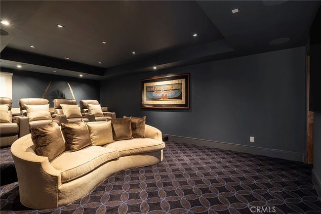 The luxe home theatre features surround sound, comfortable seating, wet bar and adjacent 3/4 bath. | Image 26
