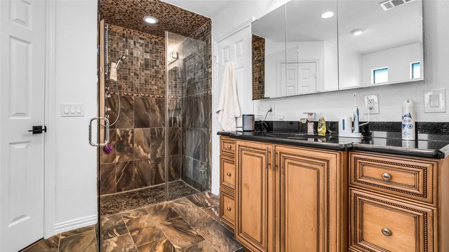Full bathroom featuring a shower stall, vanity, marble finish flooring, and recessed lighting | Image 13