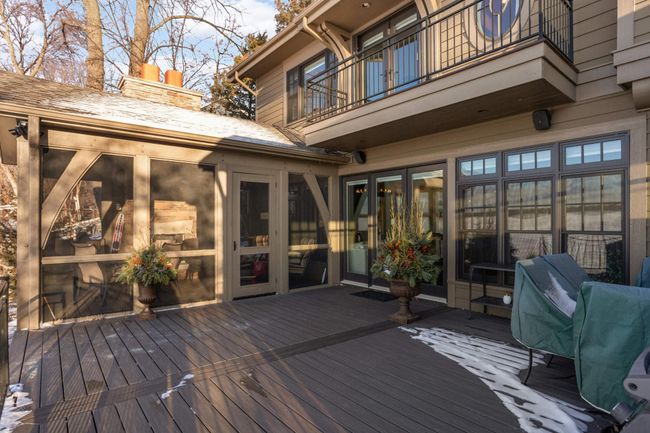 outside view of three season porch and deck. Triple doors lead to family room. Note the master deck above | Image 22