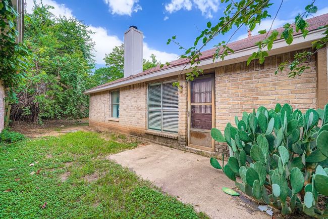 Property entrance with brick siding, a chimney, and a patio area | Image 27