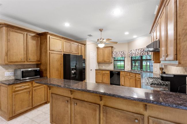 Tons of storage. Countertops topped with granite. | Image 14