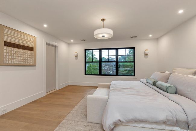 Bedroom with light wood-type flooring and recessed lighting | Image 9