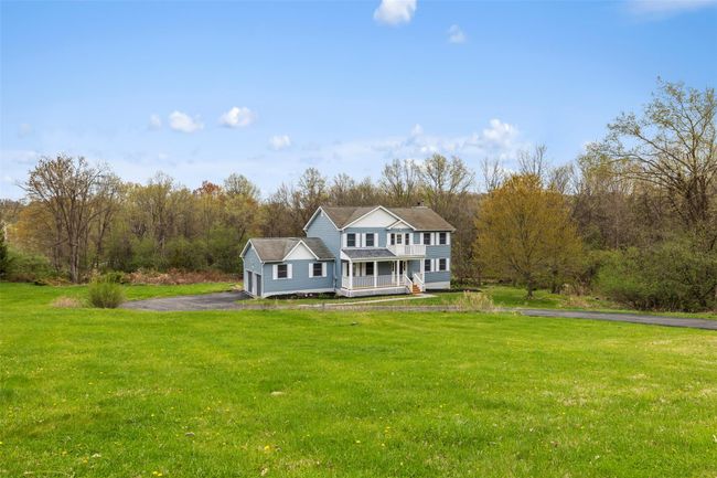 View of front of property with a porch, a front lawn, and driveway | Image 37