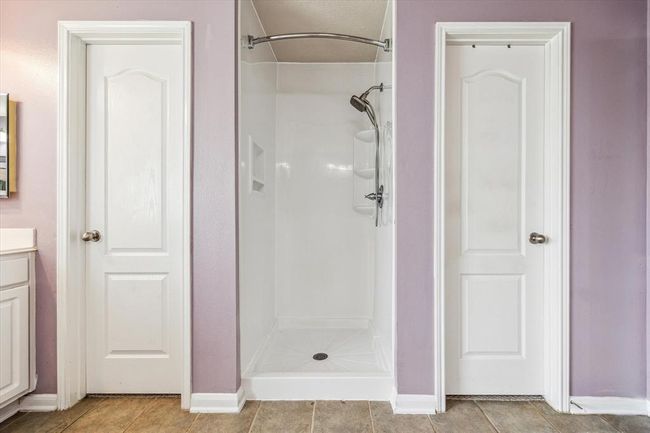 Master Bathroom shower with walk in closets on both sides. | Image 16