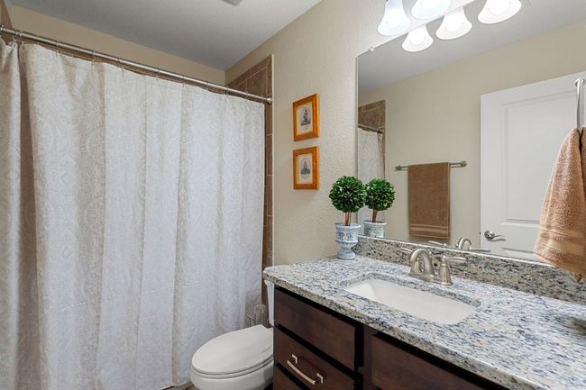 1st Floor Bathroom #2 with a textured wall, vanity, and toilet | Image 29