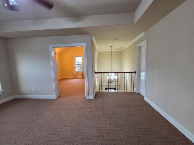 Empty room with a chandelier, carpet floors, and ornamental molding | Image 31