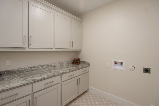 Laundry room featuring hookup for an electric dryer, cabinets, and washer hookup | Image 28