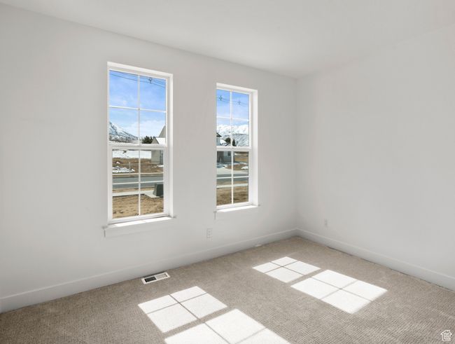 Spare room featuring baseboards, visible vents, and light carpet | Image 14