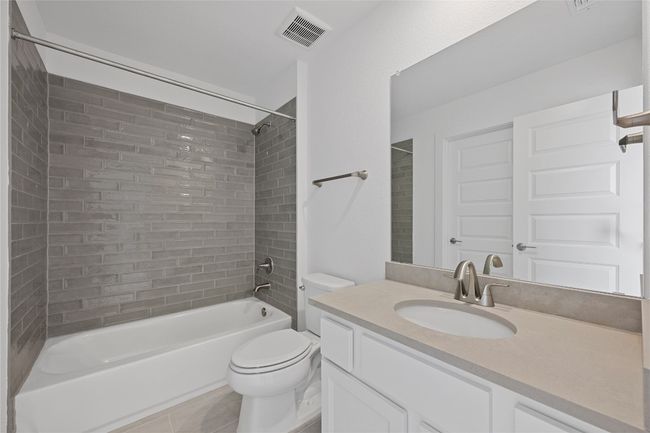 Full bath featuring toilet, shower / bathtub combination, vanity, and tile patterned flooring | Image 26