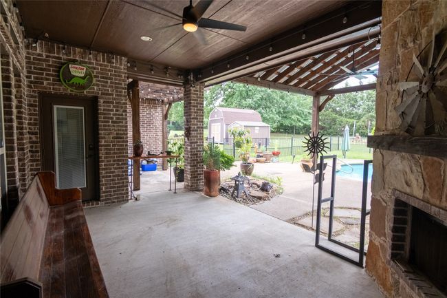 View of patio / terrace with a ceiling fan, a gazebo, and an outdoor pool | Image 33