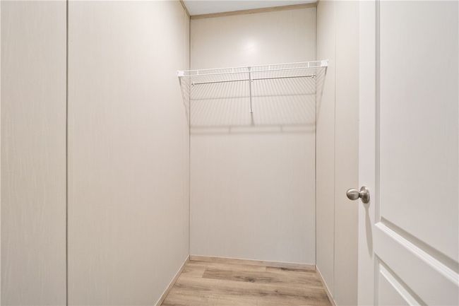 Walk in closet with wood finished floors | Image 20