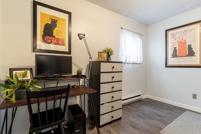 Office space featuring a baseboard heating unit, baseboards, dark wood-type flooring, and a textured ceiling | Image 12