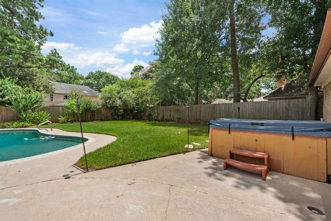 Head back downstairs and outside to see your private oasis with pool and hot tub. | Image 31