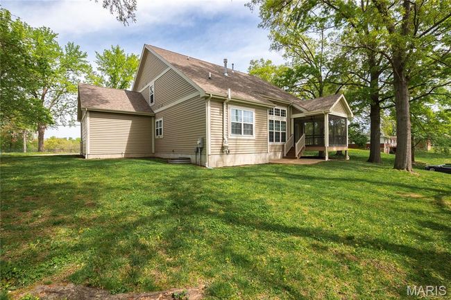 Back of house featuring a screened in porch, a yard, and a shingled roof | Image 47