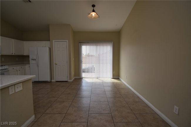 Unfurnished dining area featuring visible vents, baseboards, and light tile patterned floors | Image 8