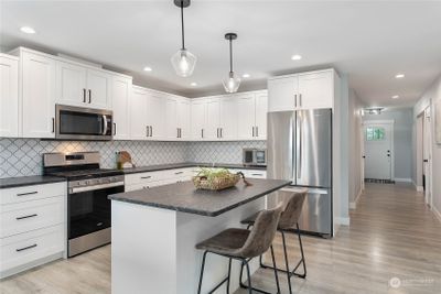 Down hall from entry - Huge kitchen w/tons of cabinets | Image 3