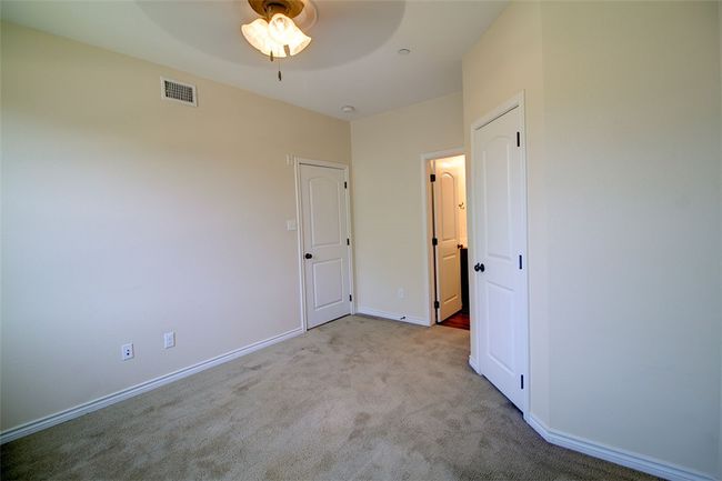 Unfurnished bedroom with visible vents, baseboards, a ceiling fan, and carpet floors | Image 12